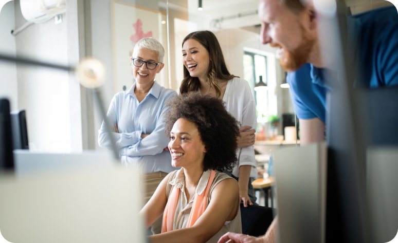 A group of finance professionals talking together in a bright office