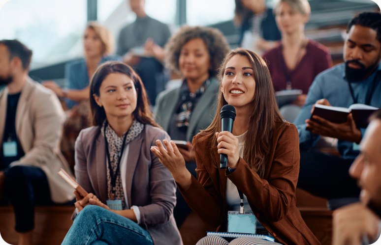 Bookkeepers at a Profit First live event, one asking a question with a microphone