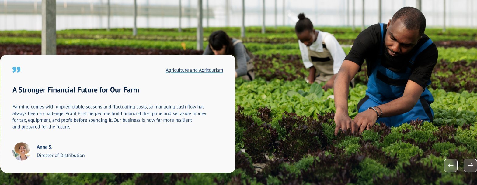 A farm worker tending rows of leafy greens in a greenhouse.